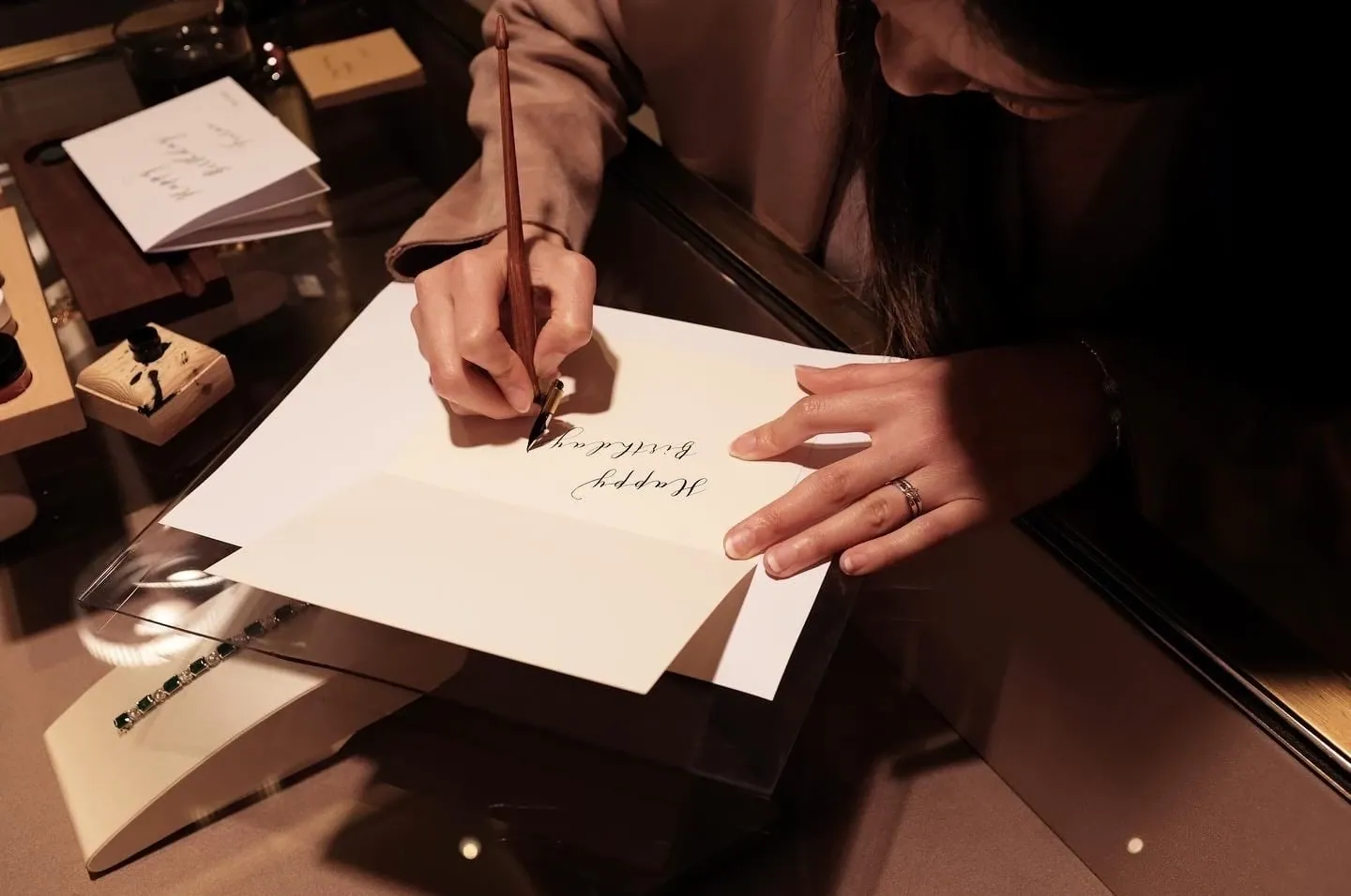 Catherine Gunarso creating personalized live calligraphy pieces for guests at a luxury event activation in San Francisco.